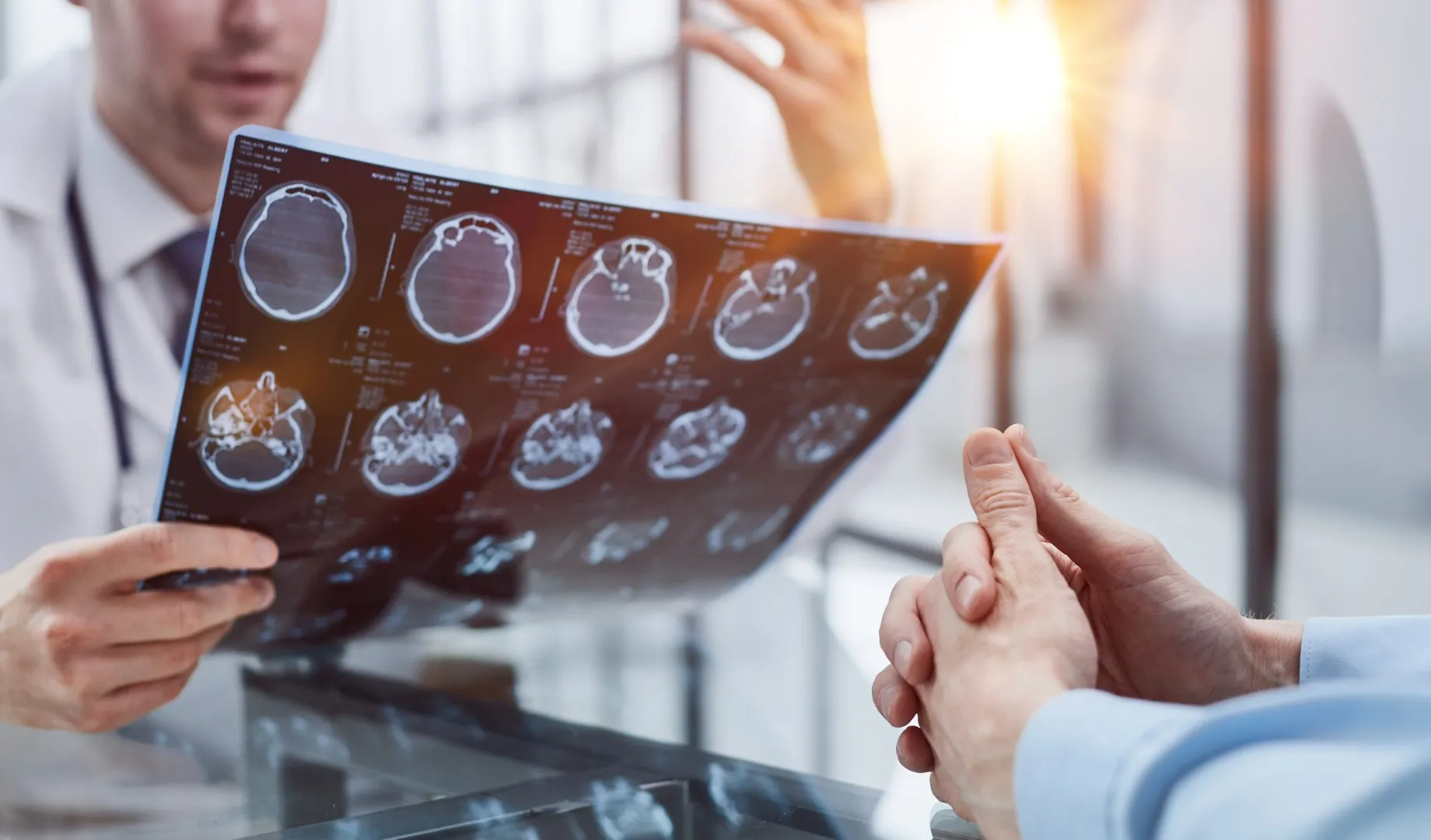 Doctor examining brain scan results after a serious injury, supporting claims often handled by a catastrophic injury attorney or workers compensation lawyer in California.