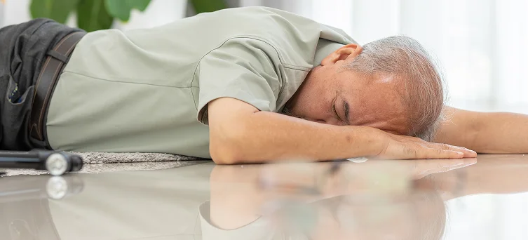 Older adult lying on floor after a fall, representing fatal injury cases that may involve wrongful death claim lawyer support.