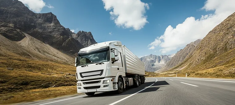 Commercial truck driving on highway symbolizing accident claims and delayed workers compensation cases handled by Los Angeles delayed claim lawyer.