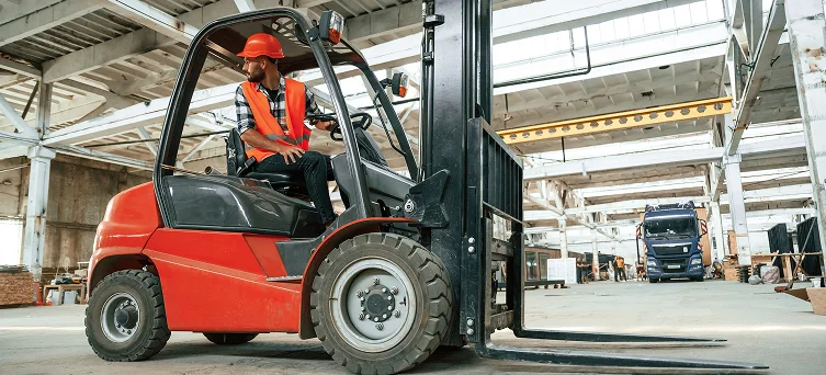Forklift operator working in warehouse representing construction and industrial accident cases handled by construction accident lawyer Los Angeles.