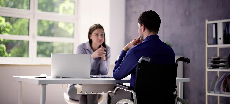 Injured worker consulting with professional after workplace accident highlighting workers compensation benefits and legal representation in California.