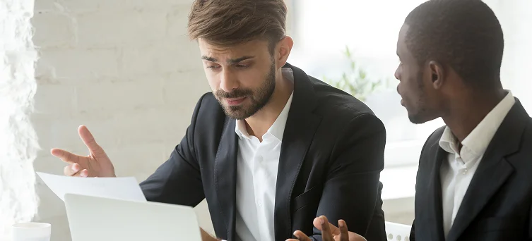 Two professionals reviewing claim documents, representing discussions about denied workers compensation cases and next legal steps.