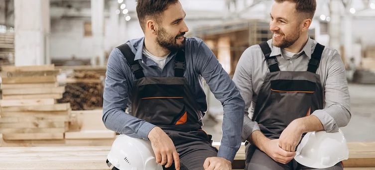 Factory workers resting during shift representing workplace environments where employees may require support from workers compensation lawyers in California after job related injuries.
