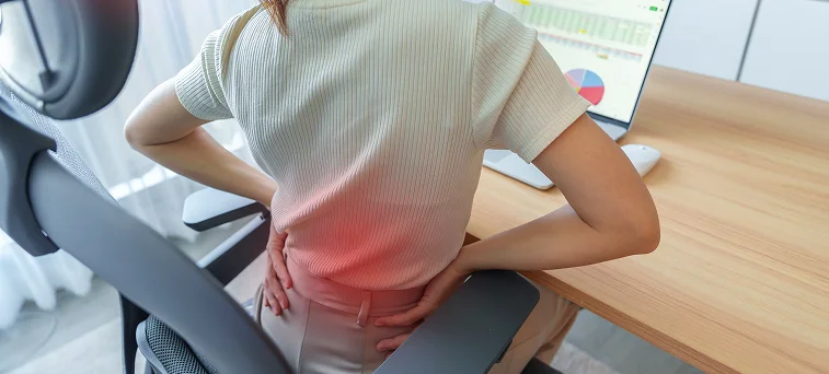 Office employee experiencing lower back pain from workplace injury highlighting cases handled by back injury lawyer California and workers compensation attorney Los Angeles.