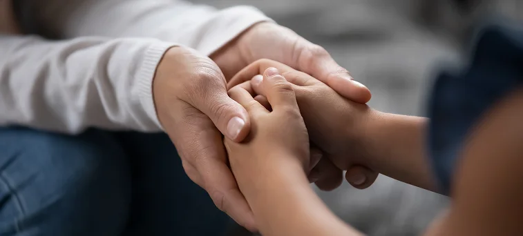 Family members holding hands showing emotional support after injury accident representing catastrophic injury attorney and wrongful death claim lawyer services.