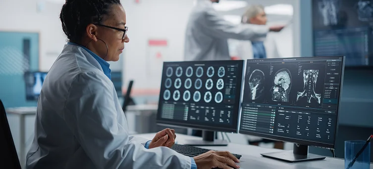 Medical specialist reviewing brain imaging for injured patient, representing catastrophic injury attorney cases involving serious workplace trauma.