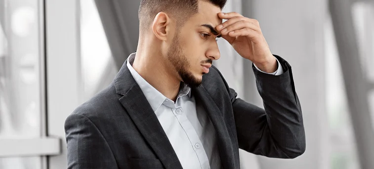 Worried employee reviewing denied claim issues, highlighting why injured workers seek help from a workers compensation attorney in California.