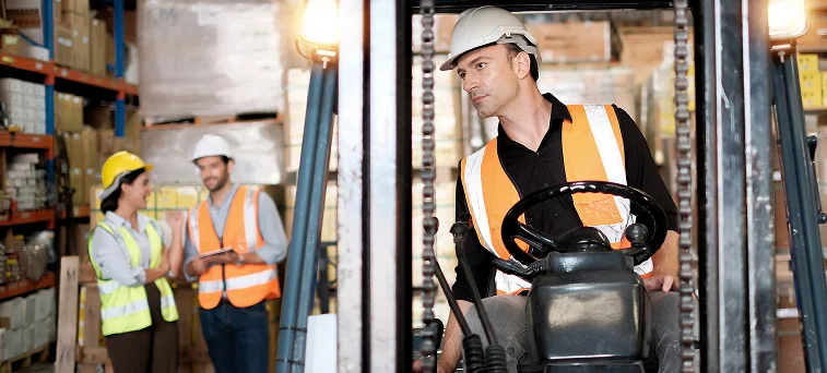 Warehouse forklift operator performing job duties symbolizing workplace accident risks covered by workers compensation lawyers in California.